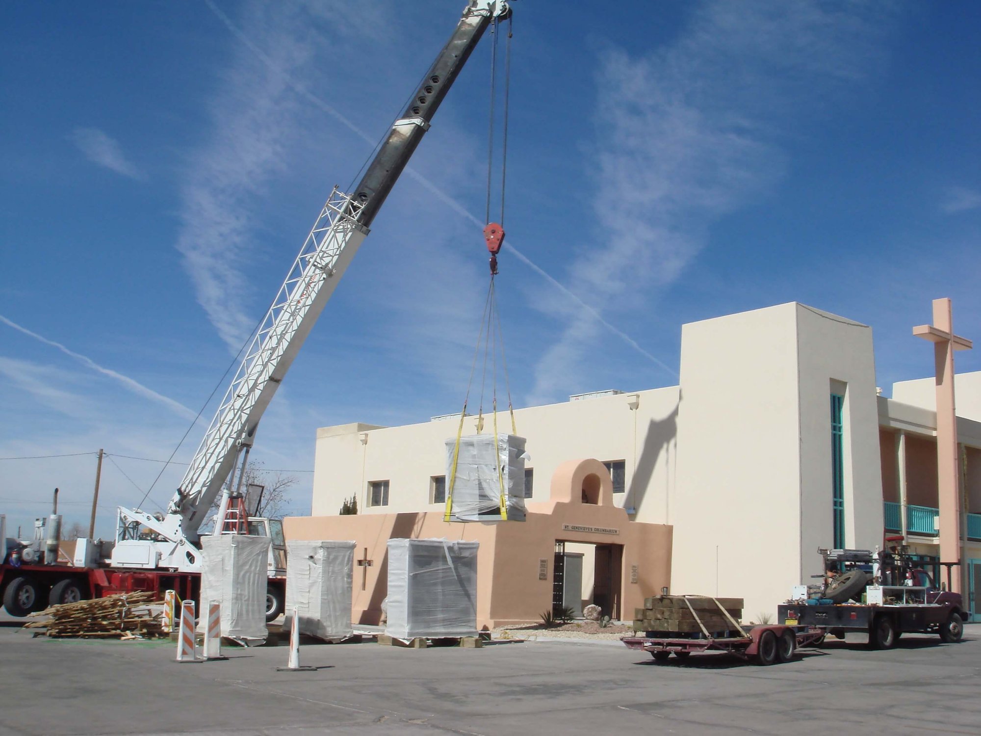 A crane lifting one of four granite community columbaria into their new cremation garden.